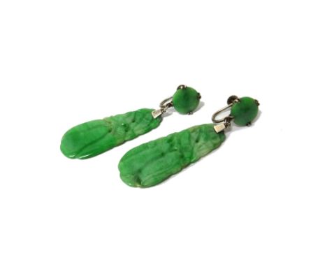 A pair of carved jade pendant earrings, each drop of tapered form, carved as fruiting motifs and with uncarved circular surmo