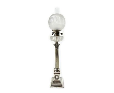 A Mappin & Webb silver plated and glass oil lamp, formed as a Corinthian column on a stepped square base, decorated with wrea