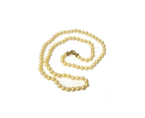 A single row necklace of largely uniform cultured pearls, the diameters approximately 9.0-9.5 mm, on a gold and diamond set c