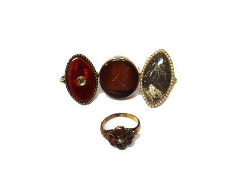 A gold ring, glazed with a navette shaped locket compartment at the centre, within a border of seed pearls and with engraved 