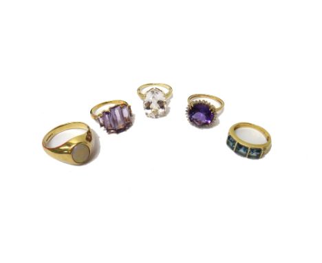 A 9ct gold ring, mounted with an oval opal, a 9ct gold ring, claw set with a circular cut amethyst at the centre, in a surrou