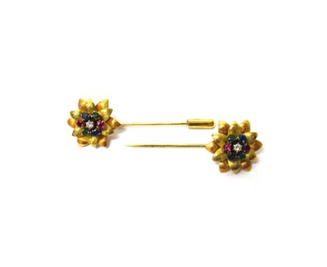 A pair of two colour gold, diamond, sapphire, ruby and emerald set pins, each with a flowerhead terminal, claw set with a cir