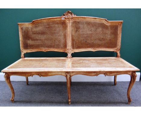 An 18th century style beech show frame sofa with opposing acanthus mounted 'C' scroll crest, over shaped bergère panels and s