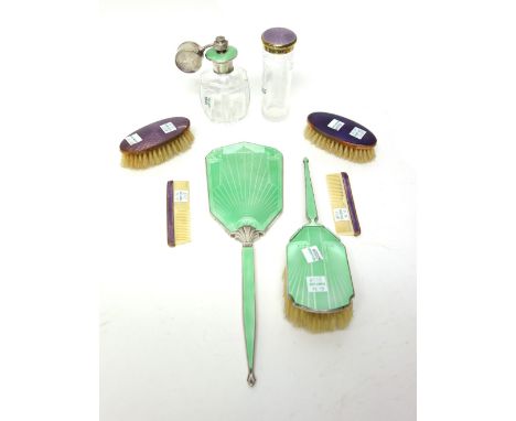 A silver and green enamel mounted hand mirror and a similar hairbrush, differing dates and designs, a faceted glass scent ato