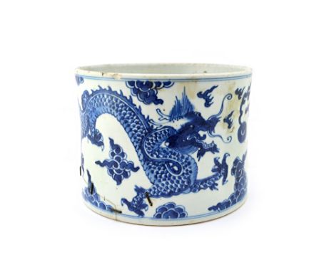 A Chinese blue and white cylindrical brushpot, Kangxi, painted with two confronting dragons chasing a flaming pearl amongst c