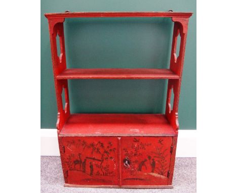 A red lacquer three tier wall shelf with pierced sides and lower cupboards, 45cm wide. 