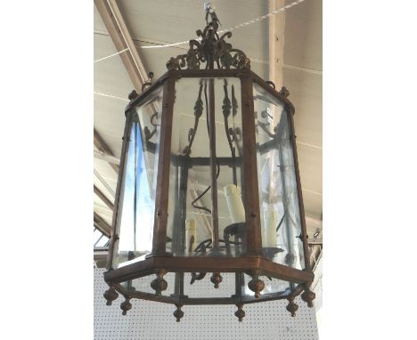 A pair of octagonal brass hall lanterns, mid 20th century, each with scrolled suspension ribs and internal four light lightin