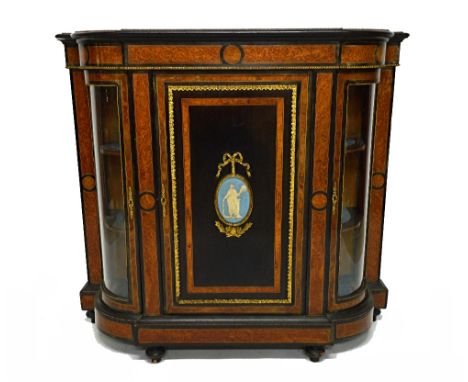 A Victorian gilt metal mounted amboyna side cabinet, the panelled central door with oval Jasperware panel flanked by a pair o