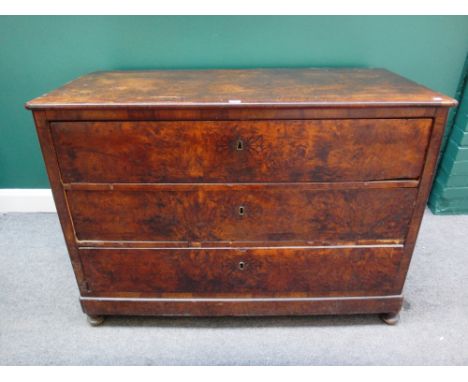 A 19th century French figured walnut commode of three long drawers on bun feet, 124cm wide. 