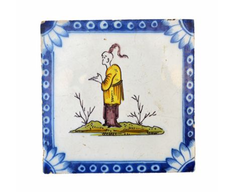 A Liverpool polychrome delftware tile, circa 1750-75, painted with an Oriental standing on grass inside a `Michaelmas daisy c