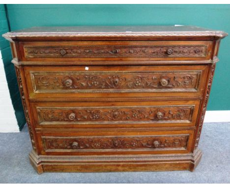 A 19th century Italian carved walnut commode, of four long graduated drawers, flanked by canted corners on plinth base, 147cm