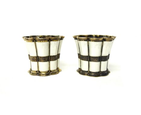A pair of Danish silver gilt and white enamel beakers of flared form, detailed A. Michelsen, Copenhagen.  