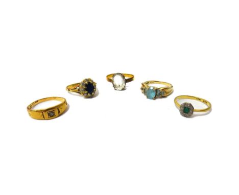 A gold and platinum, emerald and diamond set five stone cluster ring, a gold and pale blue gem set ring, detailed 9 K, a colo