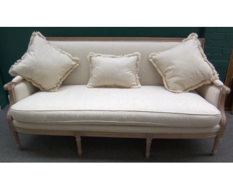 A Louis XVI sofa, the distressed grey painted frame and cream upholstery on tapering fluted supports, 190cm wide. 