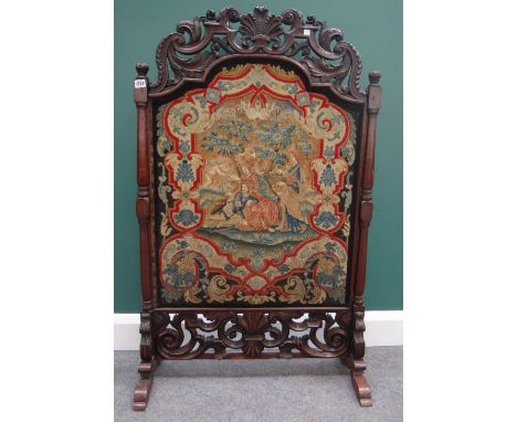 A William and Mary pierced and carved walnut framed tapestry fire screen, on later 19th century turned rosewood supports, 75c