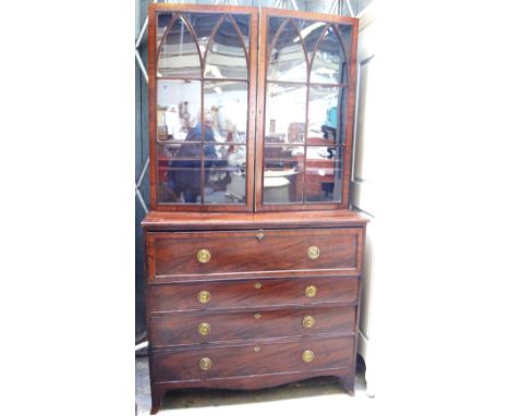 A George III mahogany secretaire chest, the pair of Gothic arch astragal glazed doors, over fitted drawer and three further l