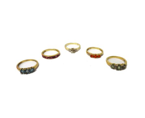 A 9ct gold and ruby set half hoop ring and four further 9ct gold and coloured gemstone set rings.