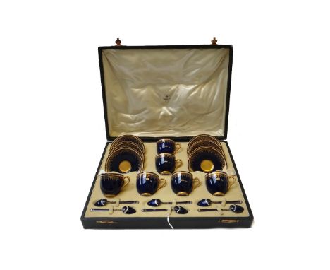 A Royal Worcester six piece coffee service, circa 1930, with gilt foliate decoration against a cobalt blue ground and jewelle