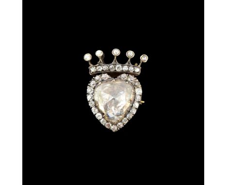 A diamond brooch, mounted with a large foil backed rose cut diamond to the centre, in a heart shaped surround set with small 