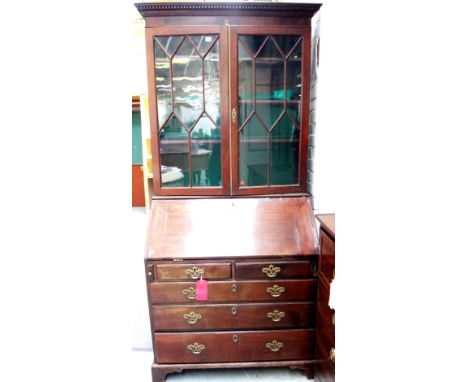A George III mahogany bureau bookcase, with a pair of astragal glazed doors over a fitted interior, two short and three long 