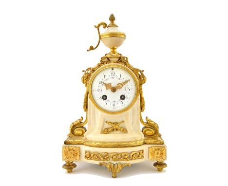 A French Empire style white marble and ormolu mounted mantel clock, late 19th century, with urn finial over a foliate decorat