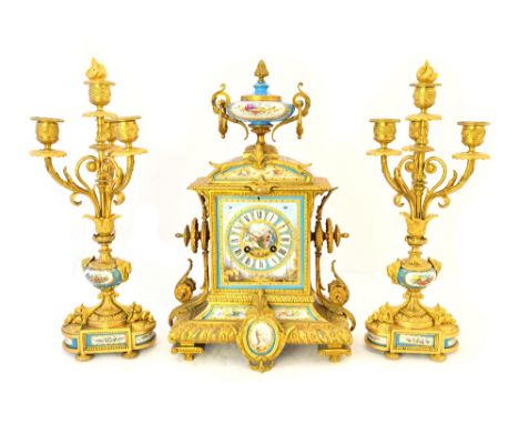 An ormolu and porcelain inset mantel clock garniture, late 19th century, with urn surmount and porcelain dial plate flanked b