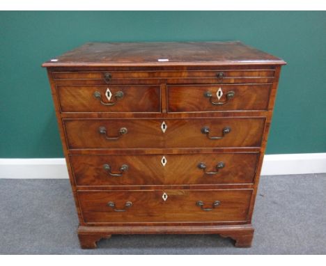 A George III mahogany chest, the brushing slide over two short and three long graduated drawers, on bracket feet, 77cm wide.