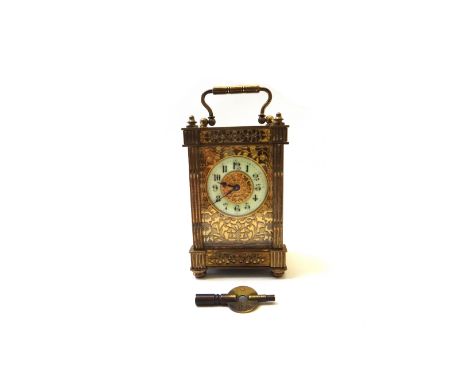A French gilt brass cased carriage clock, early 20th century, with enamelled chapter ring and foliate cast dial plate, with a