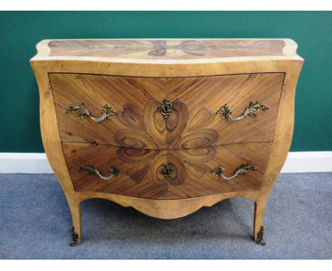 An 18th century style amboyna oyster inlaid gilt metal mounted walnut bombe two drawer commode on splayed supports, 107cm wid