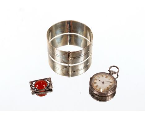 A silver bangle; a silver fob watch AF; and a silver brooch (3)