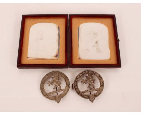Two white metal regimental&nbsp;badges,&nbsp;and a double daguerreotype portrait photograph of a man and woman, the case insc