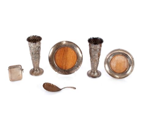 A silver Vesta case;&nbsp;a Victorian silver caddy spoon; two silver mounted small circular photograph frames; and a pair of 