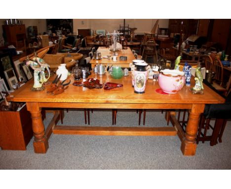 A bespoke craftsman made light oak refectory&nbsp;dining table,&nbsp;the planked top raised on bold baluster columns united b