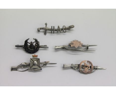REGIMENTAL TIE PINS. (5) Regimental tie pins including a silver and enamel The Wilts Regt, with rifle and bayonet. A scm/gilt