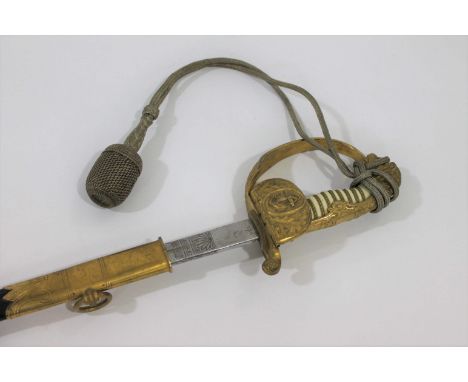 IMPERIAL GERMAN NAVAL OFFICERS SWORD a dress sword with gilt hilt, and Lion head pommel (Lion with green and red eyes), the f