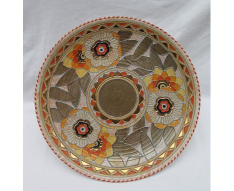 A Crown Ducal, Charlotte Rhead pottery charger decorated with orange and yellow flowers to a mottled orange ground, printed m