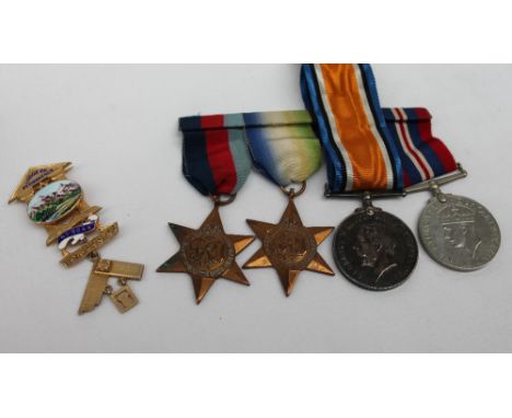 A World War I War medal, issued to 134394 Gnr. H. Obermuller R.A., together with three World War II medals including the 1939