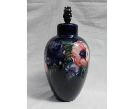 A Moorcroft pottery lamp base decorated in the anemone pattern to a royal blue ground, impressed mark and initials, 33cm high