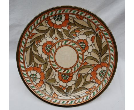 A Crown Ducal, Charlotte Rhead pottery charger decorated with orange, green and brown flowers to a mottled orange ground, pri