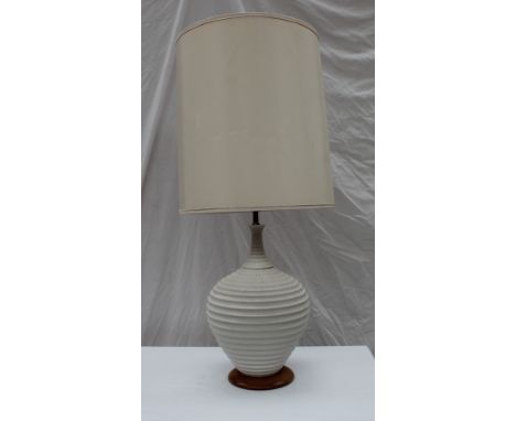 A Mid 20th century pottery table lamp, with a two section textured white pottery body and turned wooden foot, 96cm high overa