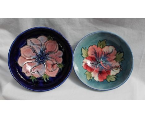 A Moorcroft pottery bowl decorated in the hibiscus pattern to a light blue ground, impressed mark, 14cm diameter together wit