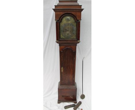 An 18th century oak longcase clock, the stepped hood with Ionic columns above a long trunk door with arched top, box base and