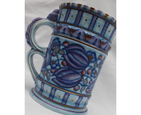 A Crown Ducal pottery handled vase decorated with purple, blue and red flowers to a mottled blue ground, printed mark, No.479