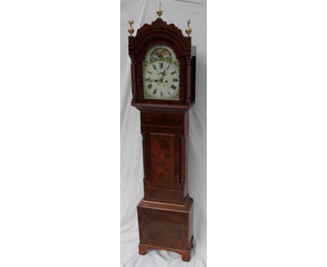 A 19th century mahogany longcase clock, the arched hood with brass globe finials and rope twist columns above a short trunk d