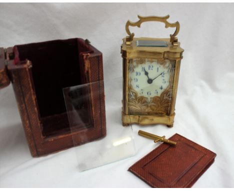 A 19th century French brass carriage clock, with a serpentine case and handle, the enamel dial with blue Arabic numerals with
