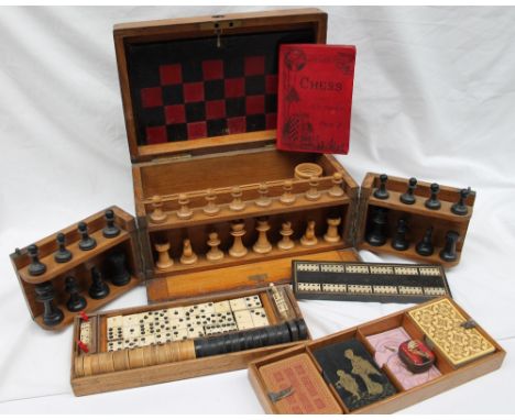 An Edwardian oak games compendium, inset with a brass plaque inscribed "The Royal Cabinet of Games" with a folding chess / ba