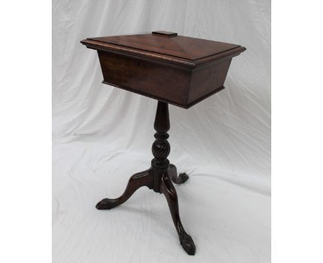A Victorian mahogany teapoy of sarcophagus form, the rectangular moulded top above a vacant interior on a leaf carved taperin