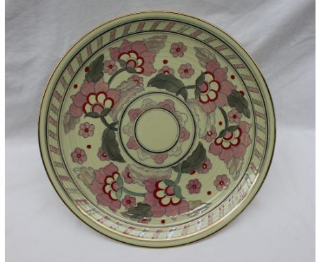 A Crown Ducal pottery charger decorated with pink and red flowers to a lime green ground, printed mark, No.2681, 32cm diamete