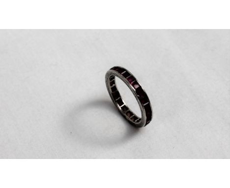 A ruby eternity ring set with princess cut rubies to a white metal setting and sides CONDITION REPORT: All the stones are pre