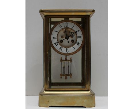 A Brass four glass mantle clock, with an enamel dial with Roman numerals and an insight movement, with a mercury pendulum, th